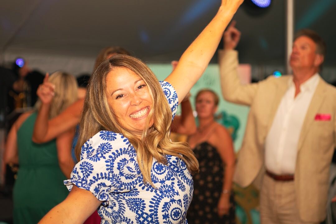 Guests filling the dance floor at an evening event.