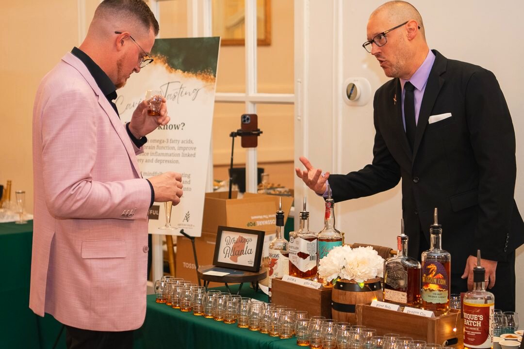 Guests gathered around a tasting table at an event.