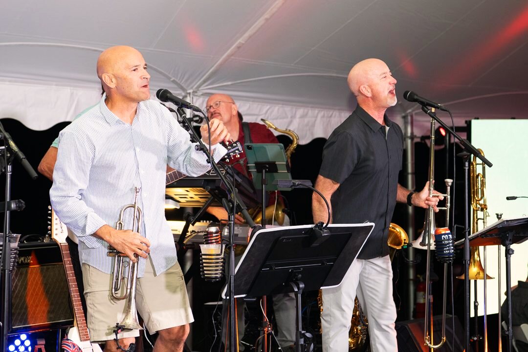 Band performing on stage during an evening event.