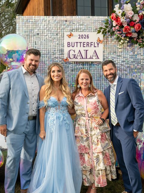 Four guests in front of the 2026 Butterfly Gala sign, cropped for Instagram.